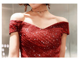 Off the shoulder sparkly red and black prom dress