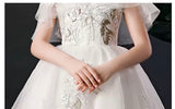 White embroidered trailing quinceanera dress