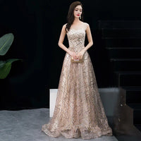 Sleeveless champagne sequin tailed prom dress