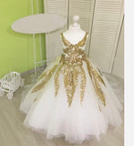 Tailed little girl's golden and white ball gown