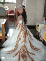 Tailed little girl's golden and white ball gown