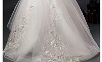 White embroidered trailing quinceanera dress