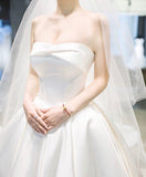 Off the shoulder ivory satin wedding dress