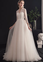 Long sleeve lace and tulle white wedding dress