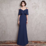 Long fitting dark blue evening dress slit on the side