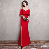 Long fitting dark red evening dress slit on the side 